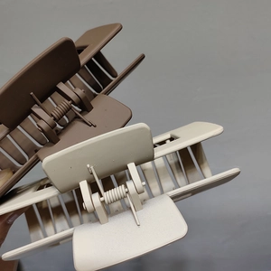 Detailed macro view showing the matte finish and durable metal spring of the large hair claws