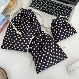 Three-piece black polka dot drawstring storage bags for cosmetics in various sizes