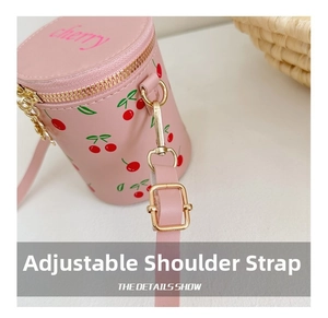 Detail of adjustable pink shoulder strap and gold hardware on cherry bucket bag
