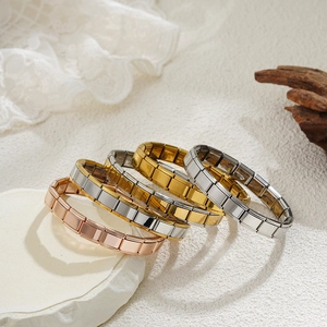 Set of four stainless steel modular charm bracelets in gold, silver and rose gold tones