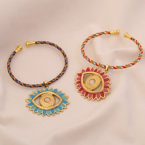 Handmade woven cord bracelets with evil eye enamel charms in blue and pink finishes