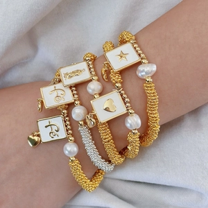 Bohemian multilayer stretch bracelet with pearls, enamel cross, heart and Fé pendants