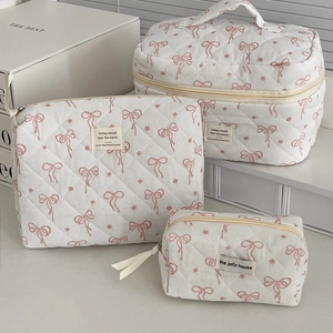 Three-piece set of quilted floral makeup bags in large, medium, and small sizes