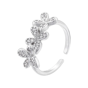 Macro shot of silver-tone open ring featuring a sparkling floral diamond cluster design