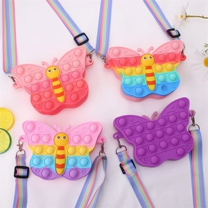 Detail showing four colorful butterfly pop silicone shoulder bags for kids with rainbow straps