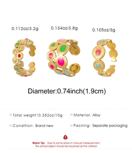 Detailed view of three bohemian gold alloy rings with colorful enamel drip oil finish