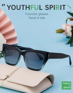 Cat eye sunglasses with black frame and blue gradient lenses on a leather case