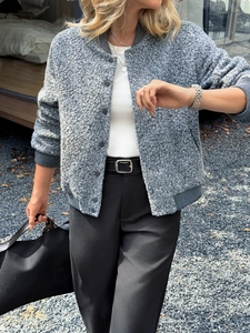 Detail of grey wool varsity jacket with button-down front and casual holiday style