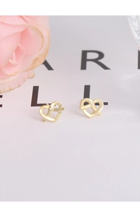 Close-up of golden intertwined heart earrings with a small white zircon stone inlay