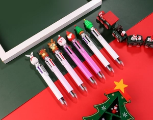 Christmas 6-color ballpoint pens with Santa and reindeer cartoon toppers on festive background
