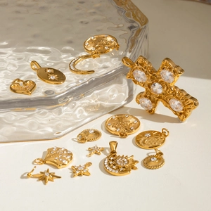 18k gold-plated stainless steel charms with crystal inlays in various shapes on glass