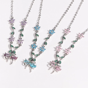 Elegant silver butterfly necklaces with purple, blue, and pink crystals on white background