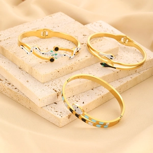 Macro detail of snake bracelets in gold finish with diamonds and colorful enamel