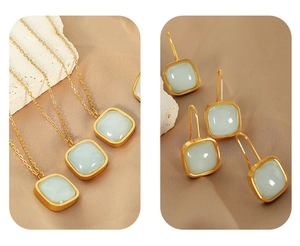 Detail view of gold jewelry set with square green jade necklaces and matching earrings