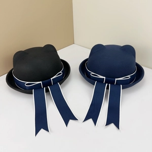 Detail of wool sailor hats featuring cat ears and long ribbon bows in black and navy