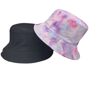 Reversible bucket hat featuring solid black and purple tie-dye print for sun protection