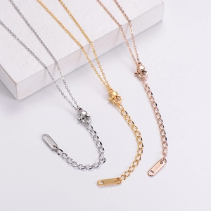 Detailed close-up of 18KGP lobster clasps and tail chains in gold, silver and rose gold