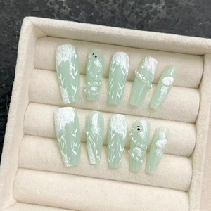 Handmade Chinese style press-on nails with green base and 3D white hand-painted patterns
