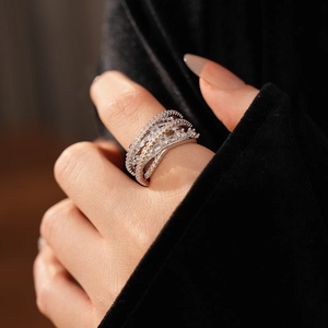 Macro shot of silver multi-layer crisscross ring set with cubic zirconia on model