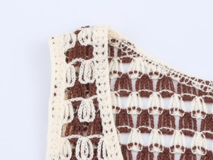 Close-up of hollowed-out crochet knit vest showing intricate wave pattern and texture