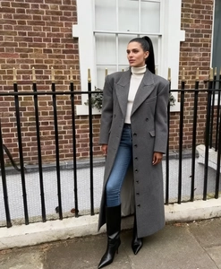 Dettaglio cappotto lungo grigio in lana doppiopetto con risvolto e vita alta elegante