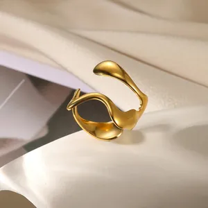 Detailed close-up of an 18K gold wave ring with an irregular minimalist organic design