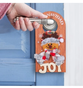 Detailed view of a wooden Christmas door hanger with a plush reindeer and JOY lettering