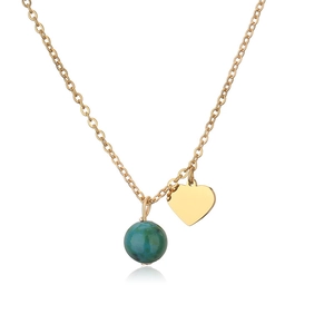 Detailed macro view of gold heart pendant and turquoise bead on a fine chain necklace