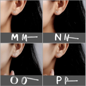 Macro detail of S999 silver letter earrings M, N, O, P with S925 hallmark stamps
