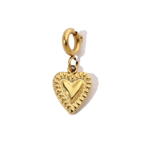 Detail of a textured golden heart pendant with radial stripes and polished metal finish
