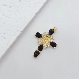 Gold cross pendant with black teardrop stone and religious embossed figure detail