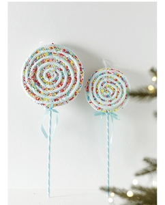 Close-up of blue spiral lollipop Christmas ornaments with colorful sprinkles and ribbon