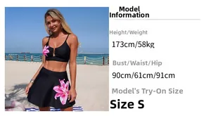 Close-up of black floral bikini with halter top, pink lily pattern, and metal hardware