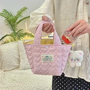 Capacity demonstration of pink quilted heart handbag with plush charm and phone inside