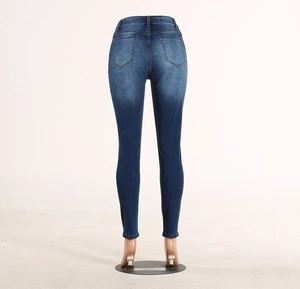 Slim fit dark blue denim jeans showing vintage washed back pockets and waist details