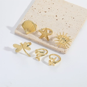 Vintage gold 6-piece adjustable ring set featuring dragonfly, sun, and sea life motifs