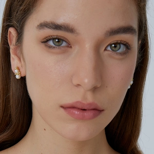 Elegant gold snowman pearl earrings for women with dual white beads on a female model