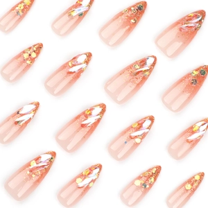 Coral pink gradient stiletto nails with gold glitter sequins and iridescent rhinestones
