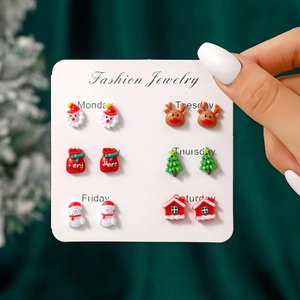 Macro view of 6-pair Christmas stud earring set featuring Santa, snowman, and reindeer