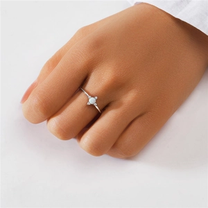 Close-up of S925 sterling silver ring with white opal stone and sparkling cubic zirconia