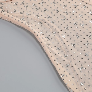Detail of nude mesh dress with sparkling crystal rhinestones and delicate texture