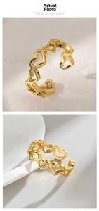 Detailed tile display of a golden hollow heart pattern open ring on a textured stone surface