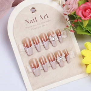 Elegant brown gradient press-on nails with white French tips, pearls, and 3D bows