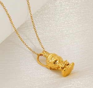 Macro shot of gold 18K plated stainless steel Monkey King pendant with detailed 0-chain