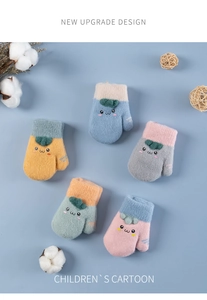 Detail of colorful children's knit mittens with cute cartoon smile embroidery