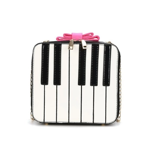 Cute piano keyboard crossbody bag with pink bow and golden chain strap for women
