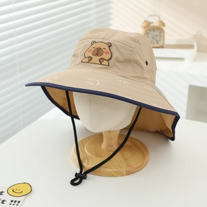 Detail view of khaki sun hat with cartoon capybara badge and adjustable windproof rope