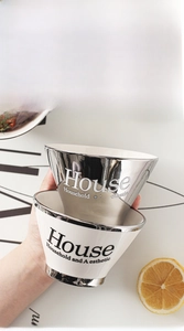 Detail of luxury ceramic bowl set with smooth glaze and silver metallic rim accents