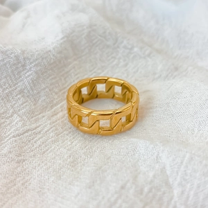Macro shot of gold-plated hollow Cuban link ring showcasing high-gloss metallic finish