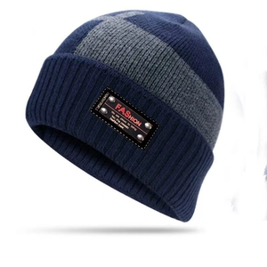 Winter knitted beanie hat in navy blue and grey stripes with fashion logo patch